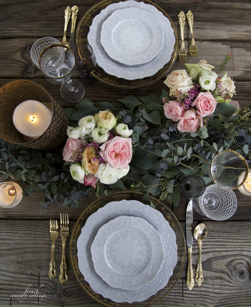 fresh and faux florals with table setting on rustic wooden table 