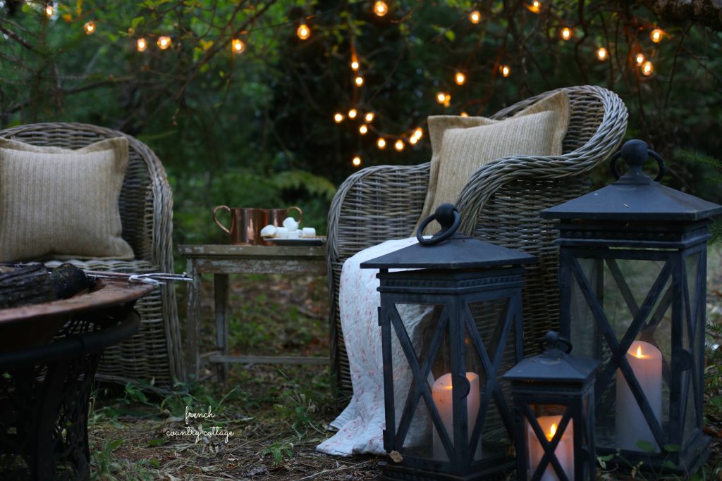 Candle-lit lamps brighten an outdoor space