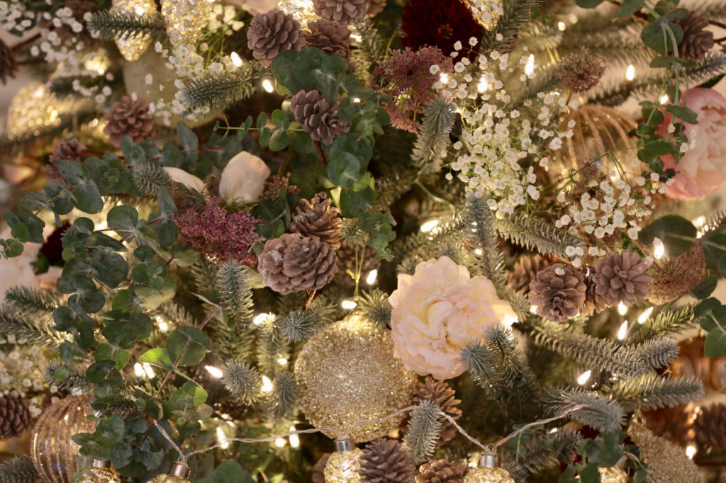Summer Christmas tree decorated with pinecones and flowers in a French Country Cottage