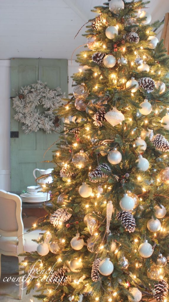 Pre-lit Christmas tree decorated with woodland country theme such as acorns and berries