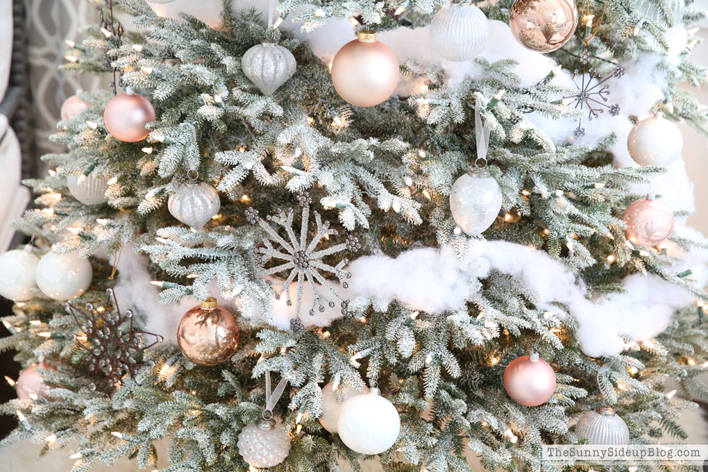 Close up of frosted Christmas tree with ornaments and decorations