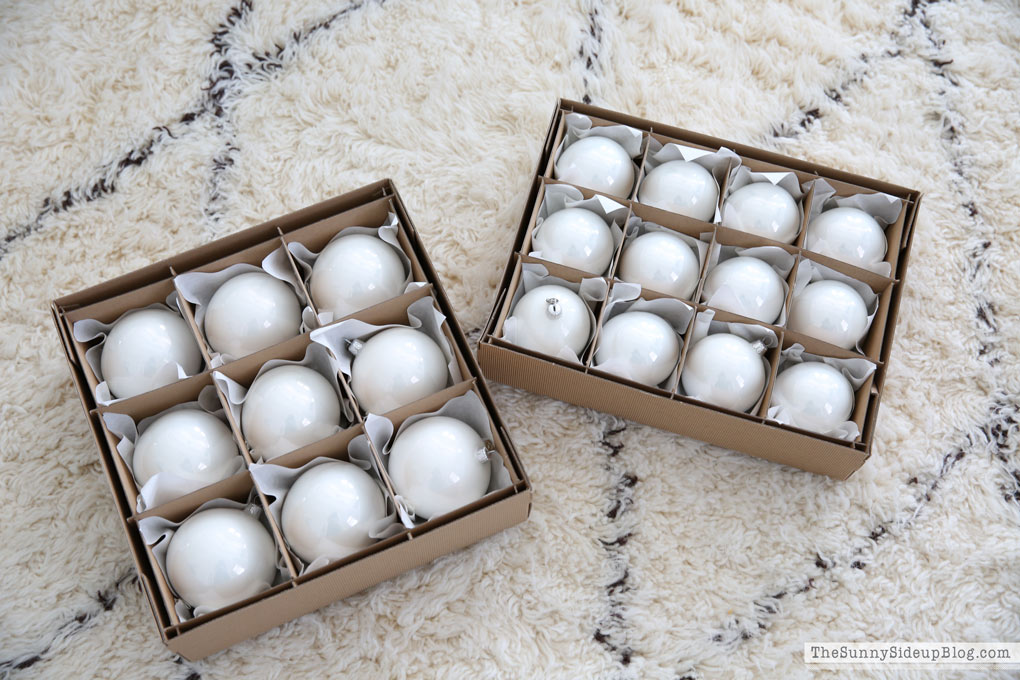 Boxes containing white Christmas tree balls