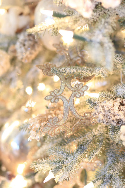 close up of glittered ribbon on frosted tree