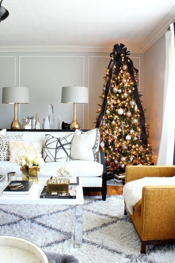 A living room with lit-up Christmas tree in a corner