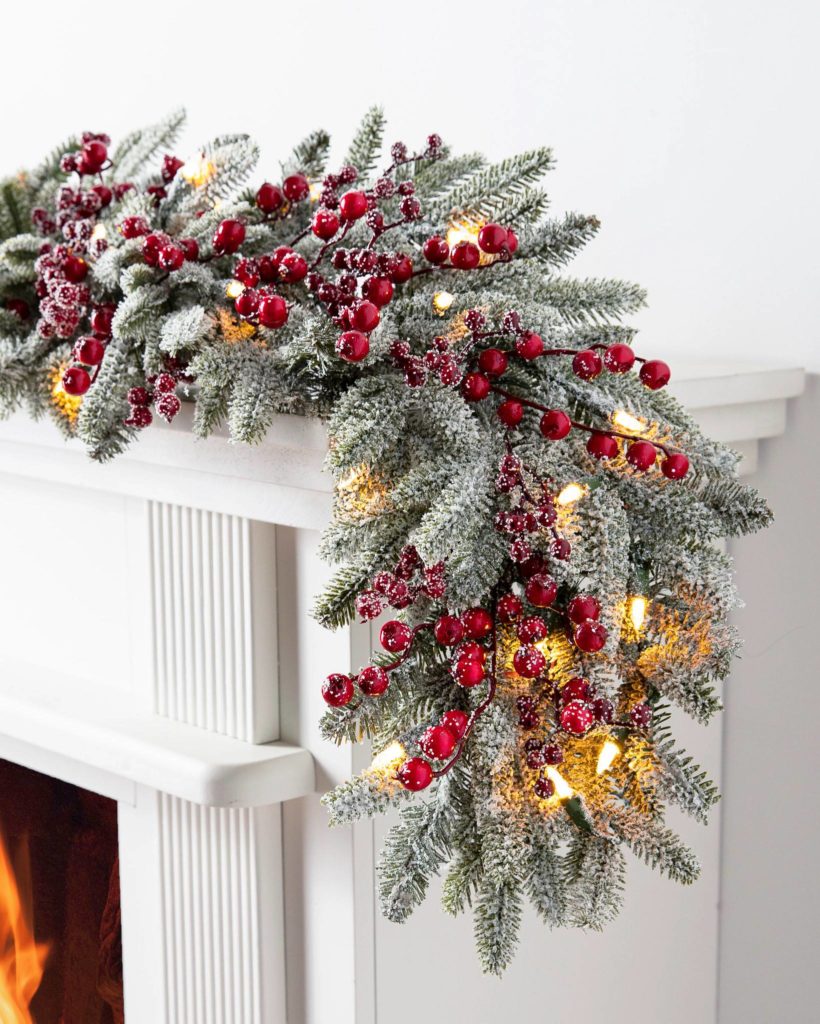 Balsam Hill Red Berry BH Frosted Fraser Fir Christmas Garland on top of a fireplace mantel