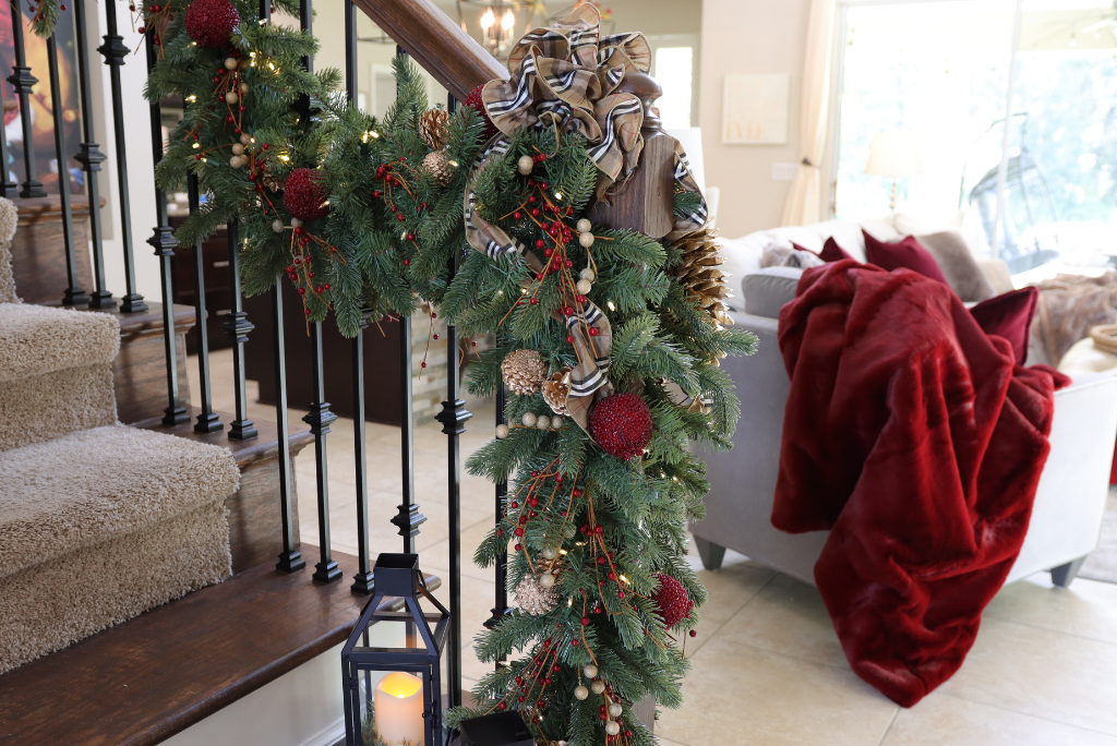 A red and gold Christmas garland on the staircase