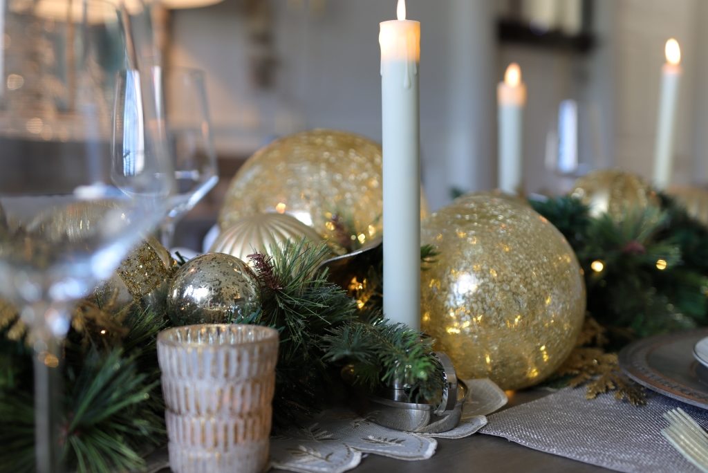 LED taper candles as part of a Christmas centerpiece for dining table