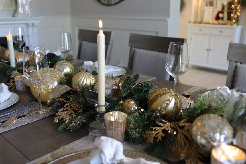 Christmas table settings with garland centerpiece and candles