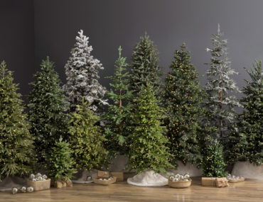 A lineup of different types of artificial Christmas trees