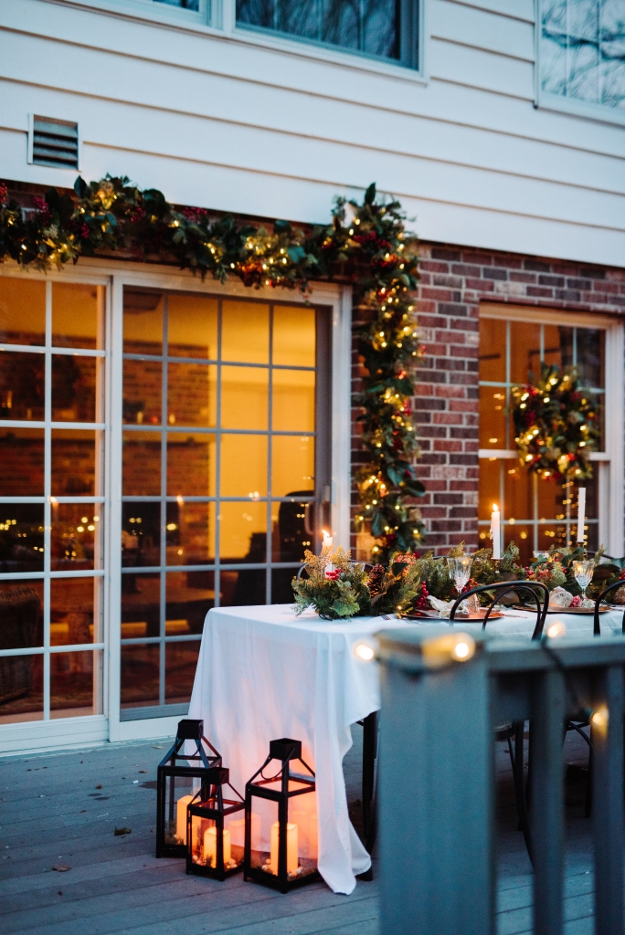 Patio decorated with an outdoor garland and lanterns