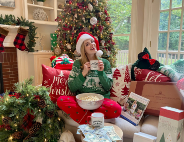 Jen Lilley sitting in front of a Christmas tree for Christmas is Not Cancelled