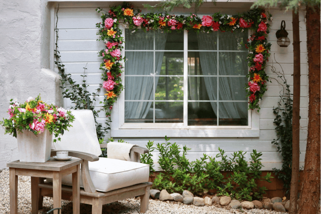 Outdoor-safe artificial floral wreaths, garlands, window boxes, and potted foliage as spring window decorations
