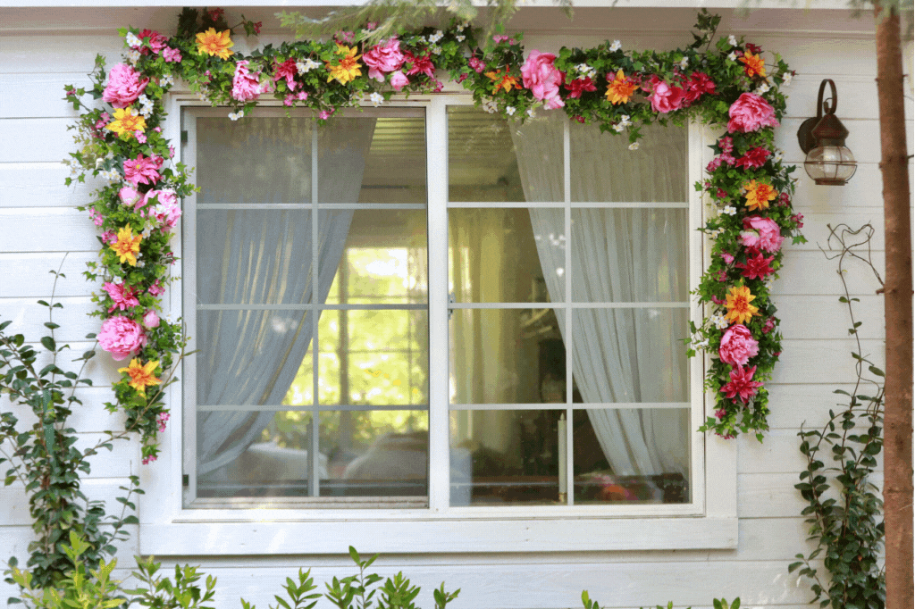 A floral wreath, garland, and window box used as spring window decorations
