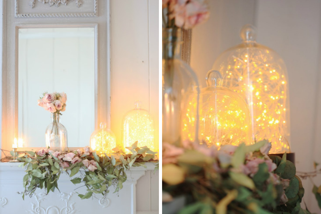 Fairy lights inside a cloche on top of a mantel