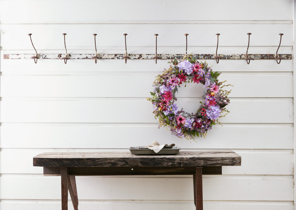 Purple floral wreath hung by the mudroom