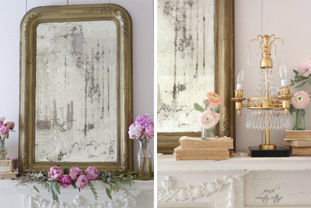 Mantel decorated with a gold mirror, lamp, and pink flowers