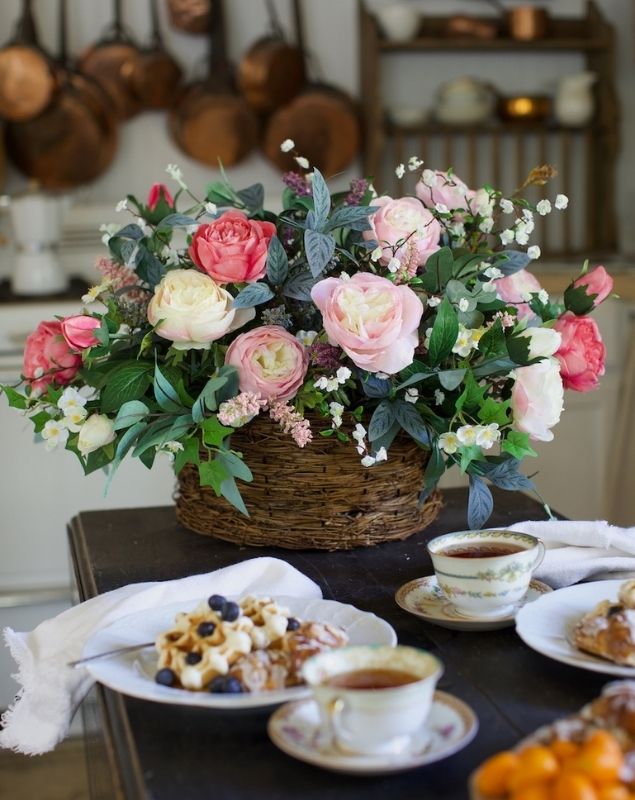 A bouquet of roses set in a basket as a spring floral arrangement