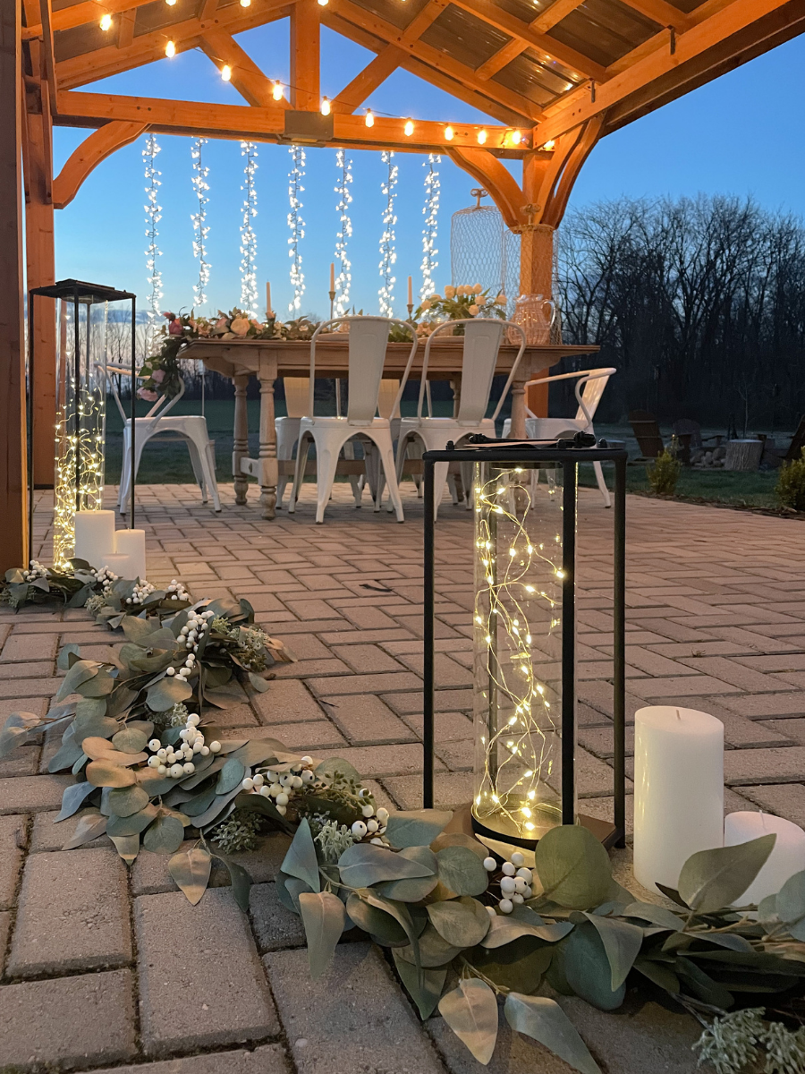 Fairy light lanterns and micro LED cascading lights as outdoor wedding reception decorations