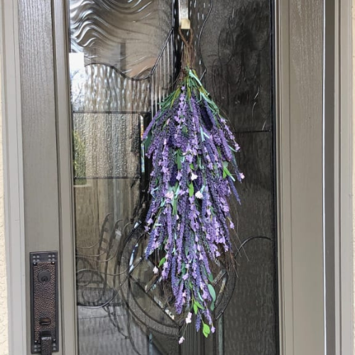 Balsam Hill Provencal Lavender Swag hung on glass door as one of the best quality artificial flowers