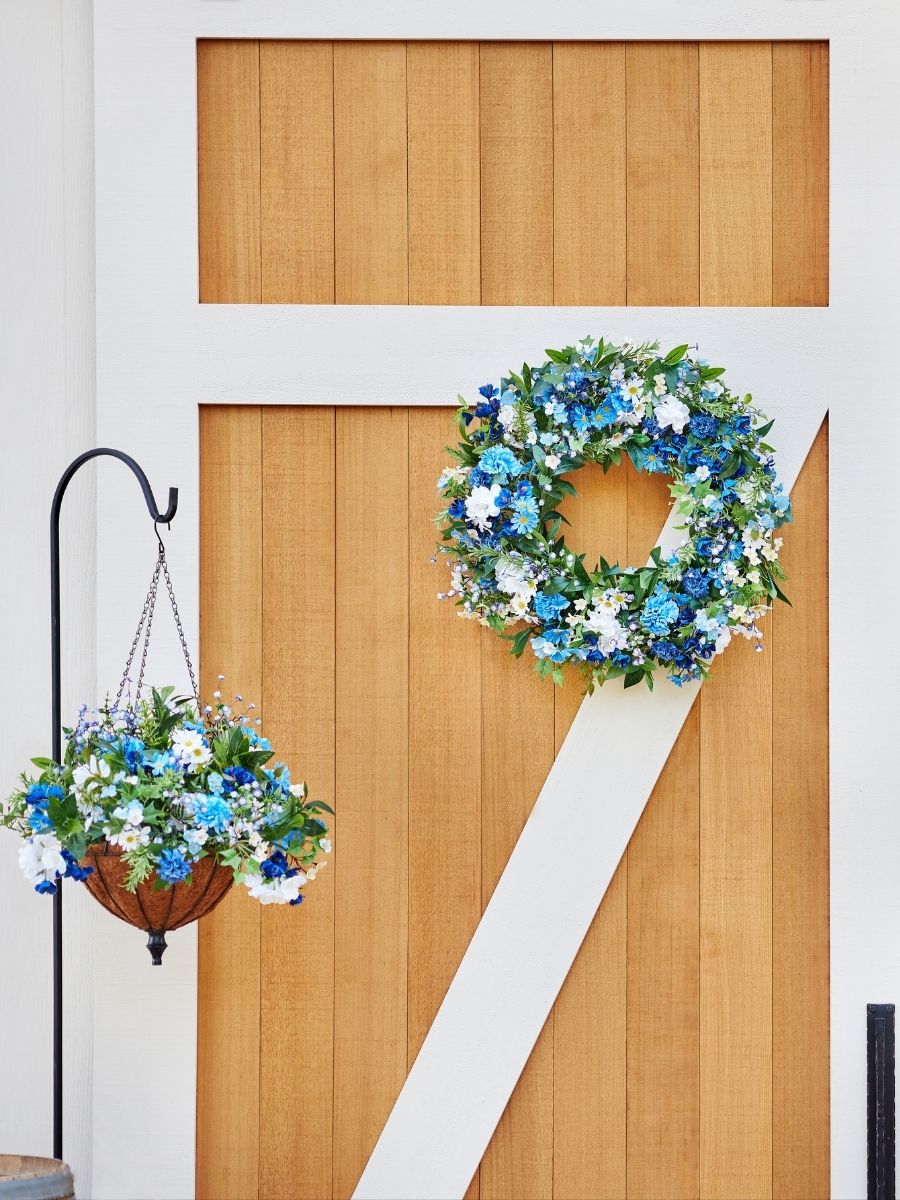 Blue and white floral wreath and hanging basket as coastal spring theme decorations