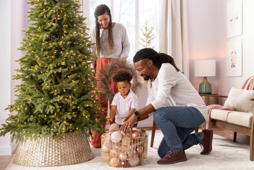 A family about to decorate an artificial Christmas tree