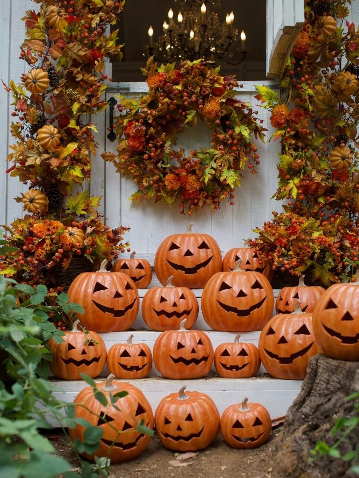 Clusters of Jack-o'-Lanterns on porch steps as fall and Halloween home decor