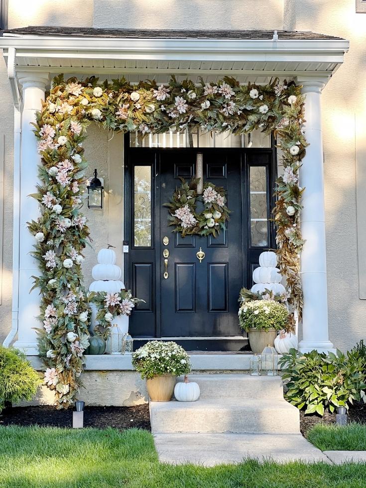 A front porch decorated with a neutral fall color palette