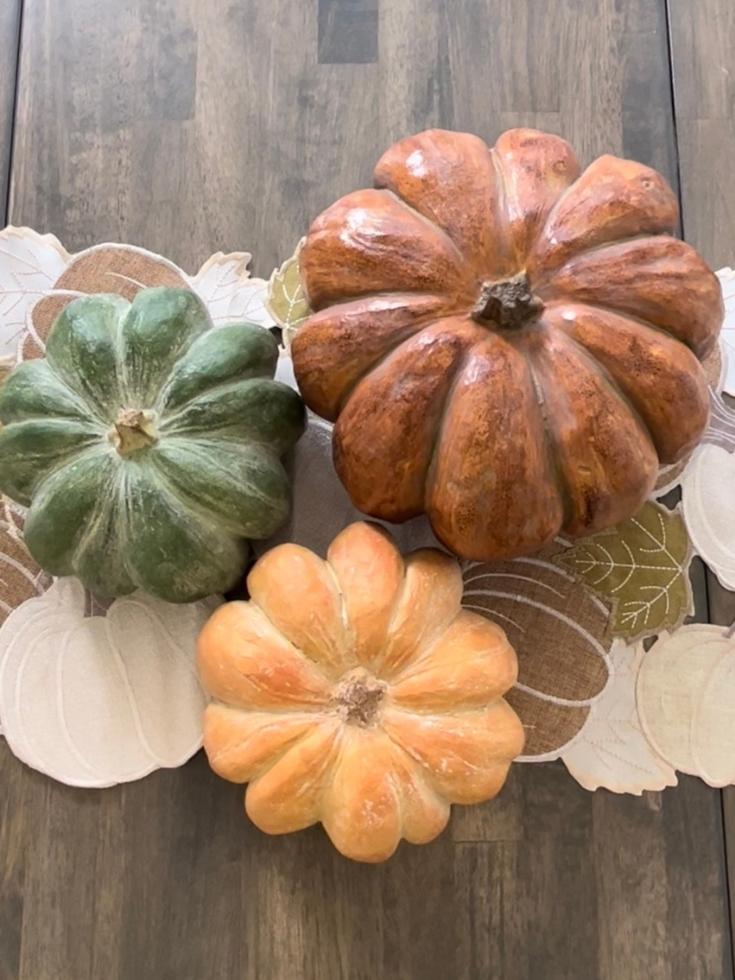 Tabletop faux pumpkins to decorate with fall colors in the dining room