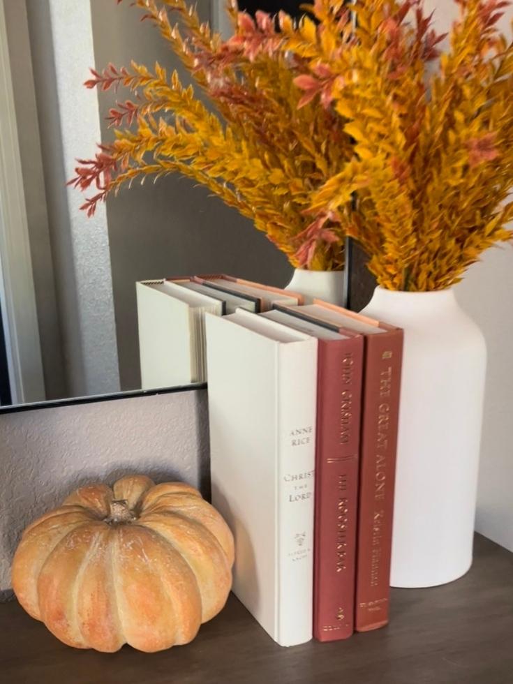 A small orange pumpkin used as pops of fall colors for home decor